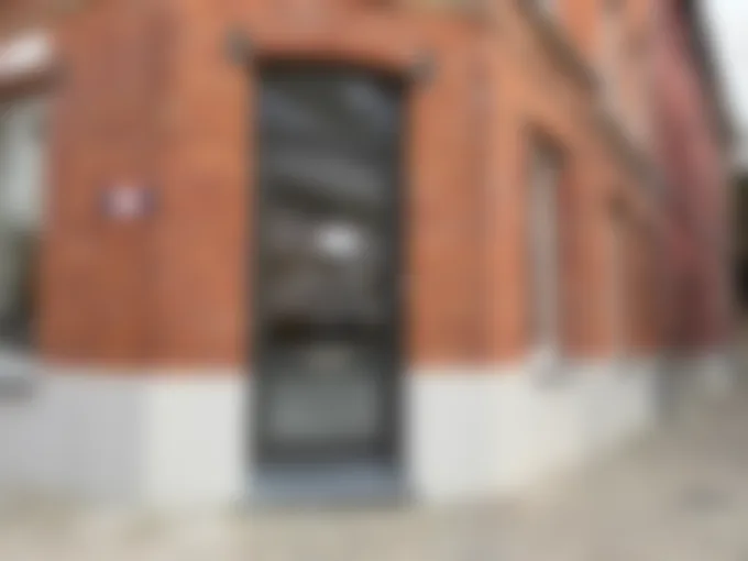 Brick exterior and entrance of the UUG.AI office at Bijlokehof 11 in Ghent